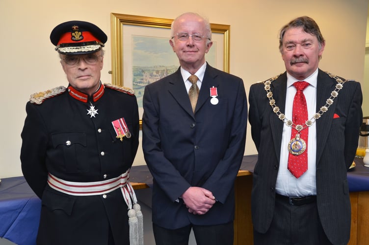 Dr John Harrison, Organist and Director of Music at St Mary's Church, was awarded the British Empire Medal for services to music in the town in 2015. He is pictured at the ceremony with the then Lord Lieutenant and Chairman of Pembrokeshire County Council.