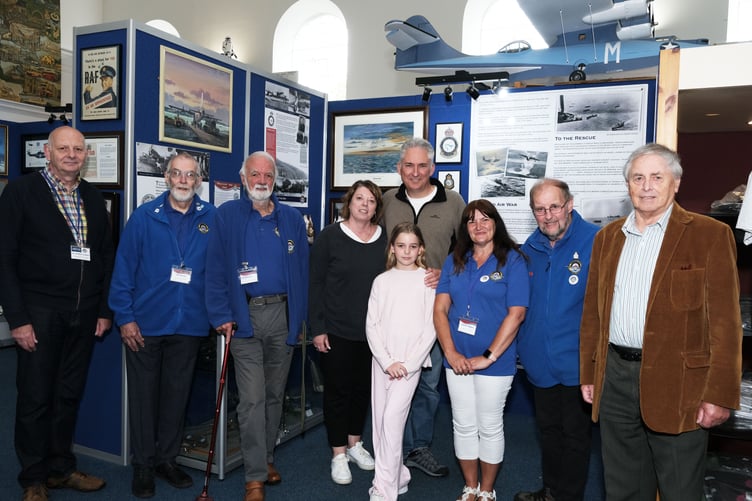 Group Captain Scott Woodland, his wife Megan and daughter Ava, pictured with John Rattenbury (right) and trustees and volunteers of Pembroke Dock Heritage Centre.