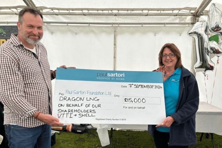 Dragon LNG and Dragon Energy MD, Simon Ames presenting the cheque to Sandra of Paul Sartori at Dragon’ staff and community celebration event.