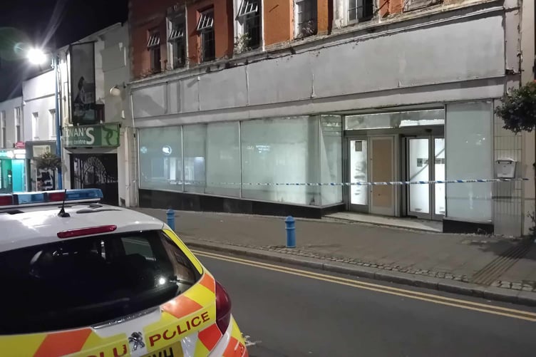 Police vehicle and tape at the former Woolworths store, Dimond Street, Pembroke Dock, on September 3.