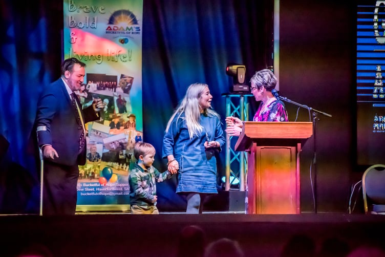 Laurence Blackhall and Sam Skyrme-Blackhall congratulate Sarah Davies on winning the Bethel Chapel Pembroke Dock sponsored Good Neighbour Award