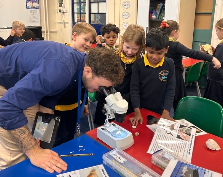 Mr Jones examining a shell with St Teilo’s School Tenby pupils
