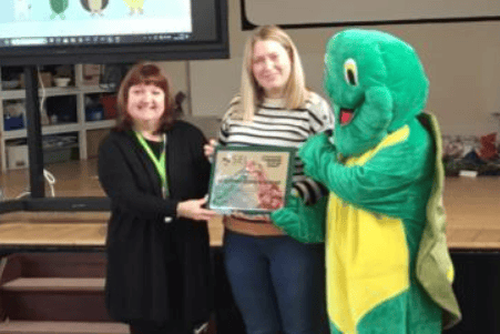 Mrs O’Leary receiving the Model Pre-School Award from Claire Sell and Twiggle from PATHS