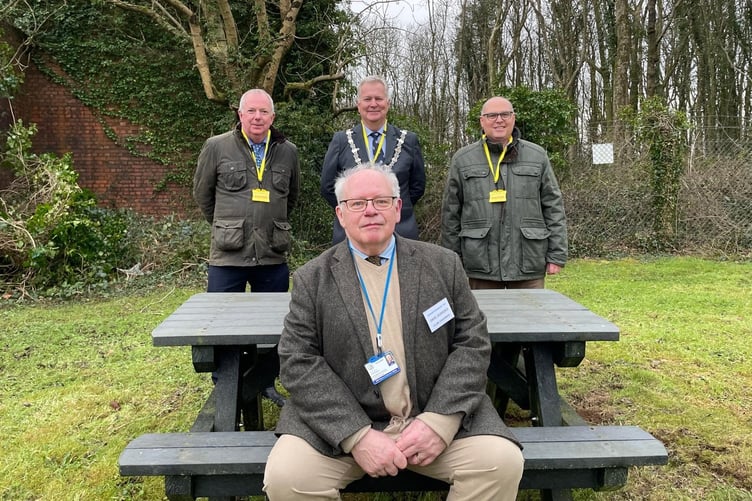 David Scheeres, Chairman. Haverfordwest Target Shooting Club – sitting. Behind Mr Scheeres are Cllr Jon Harvey, Leader of Pembrokeshire County Council, Cllr Martin Lewis, Mayor of Haverfordwest, and Senedd Member Paul Davies.