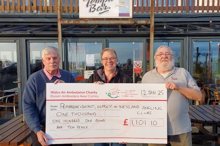 Presenting the cheque to Mike May on behalf of the Air Ambulance following the 21st Wales Air Ambulance Open Beach Fishing Competition at Amroth are Peter Kraus and John O’Connor. Photo: Mike May