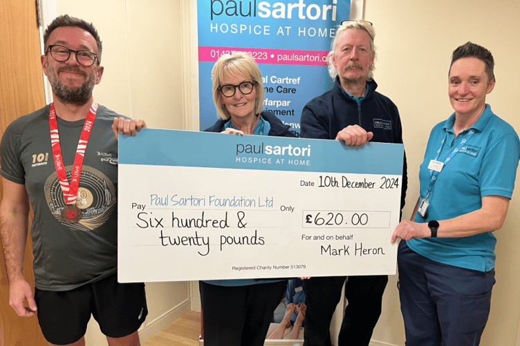 Nothing daunted following the cancellation of The Great South Run last year, Paul Sartori Community Choir director Mark Heron laced up his running shoes and completed his own 10-mile run in Carmarthen, raising £620 for the hospice at home charity. Mark is pictured with Clinical Coordinator and Equipment Facilitator Pat Coombs, and Equipment team members Jerry Hilliar and Amanda Elmes.