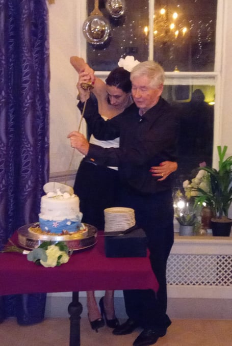 Local author Cyril James Morris, Lt Cdr, Rtd, and his wife Louise using Cyril’s ceremonial sword to cut their wedding cake during their reception at The Belgrave Hotel, Tenby.