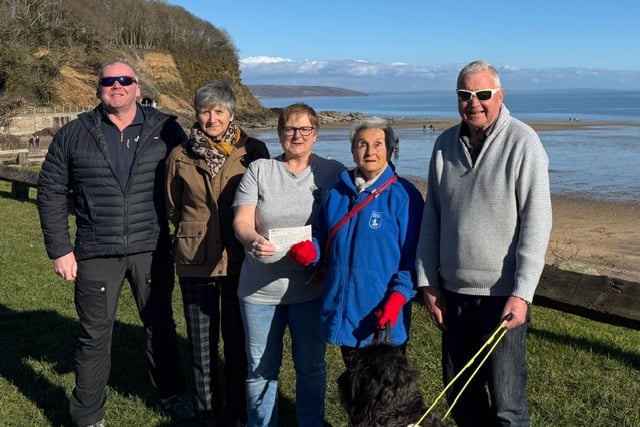 Tenfoot Swim representatives donating the £1,125 raised to local Guide Dogs Cymru branch members. Pictured, from left to right: Anthony Mattick, Kim Denning, Lynn Knibbs, Eva Rich, Adge John and guide dog Skip