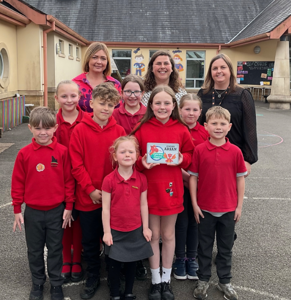 Pembrokeshire Local Authority's Catrin Phillips visited Narberth Community Primary School on Wednesday to present an award for achieving silver status in the Siarter Iaith. She is pictured here with Headteacher Mrs Kate Moore, Criw Cymraeg leaders Chloe Ormond and Meinir Lloyd and pupils in the Welsh and English streams.