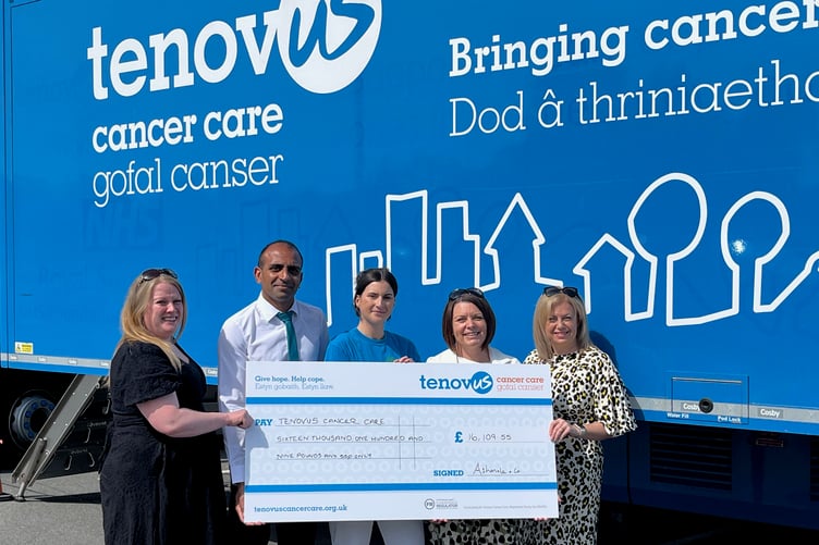 Ashmole & Co Partners Christine Daultrey, Vinal Patel, Sharon George and Laura Craddock handing over a cheque for £16,109.55 to Clare Davies (centre), Regional Fundraising Manager for Tenovus Cancer Care outside one of the mobile support units.