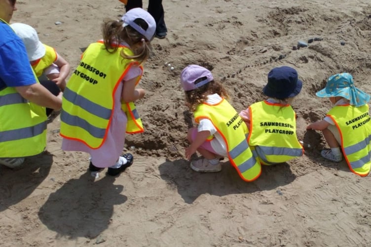 Children creating sand sculptures on Saundersfoot beach