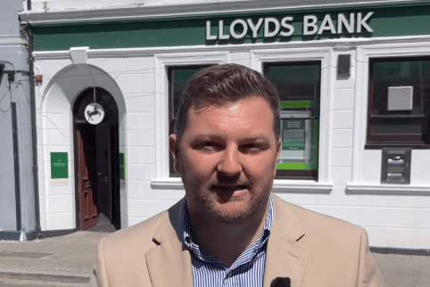 Samuel Kurtz MS outside Lloyds Bank closing branch Pembroke Dock