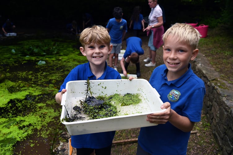 Pupils from Sageston CP School exploring the onsite pond