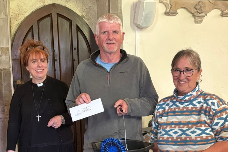 St Florence Church potato challenge - Pictured with Rev’d Martine are Adult Class winners Lawrence Mathias (largest number) and Paula Jeffrey (heaviest crop)