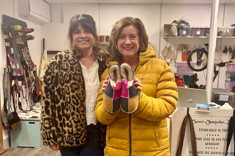 First Minister of Wales, Eluned Morgan, choosing a pair of slippers at the Susie’s Sheepskin Boots shop in Tenby’s Old Market Hall