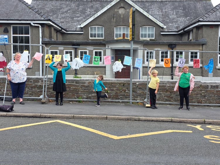 Claire Warren (left) her daughter Charlotte (far right) and other pupils outside Carway Community Primary School, Carmarthenshire
