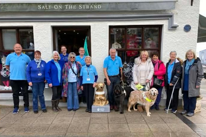 Volunteers from Guide Dogs Pembrokeshire at the unveiling of the gold-coloured collecting box