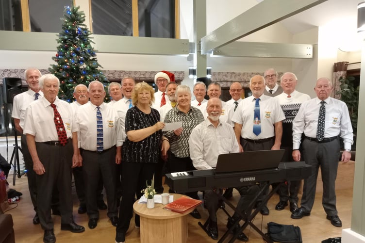 On behalf of residents at Kensington Court, Steynton, Rosemary Cooper presented a donation to Pembroke and District Male Voice choir.