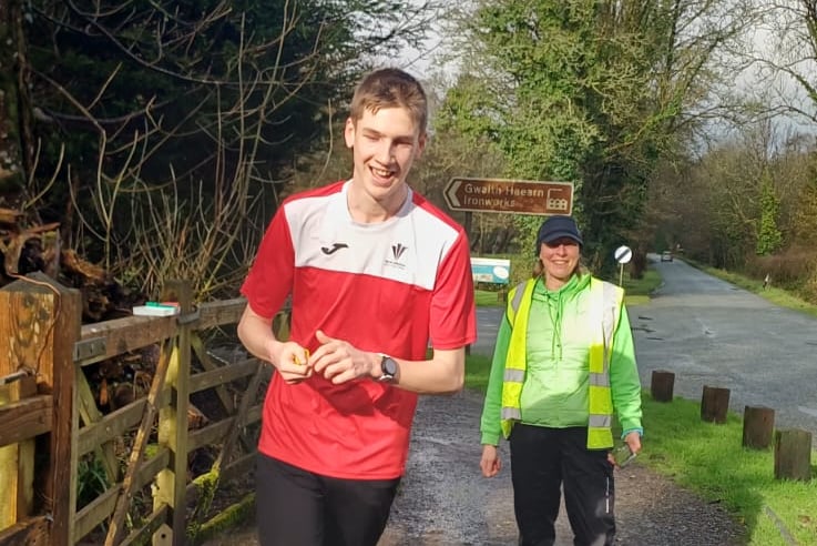 Jay passing Rachel Holland on Fourth Food Bank Run