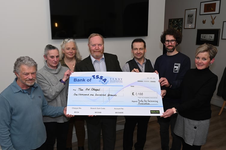 Ian Rees of The Old Chapel, Tenby, is presented with a Boxing Day Swim cheque to help the community facility.