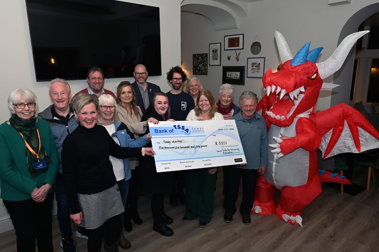 Tenby Boxing Day Swim mascot Dilys the Dragon joins the celebration of the event's success.