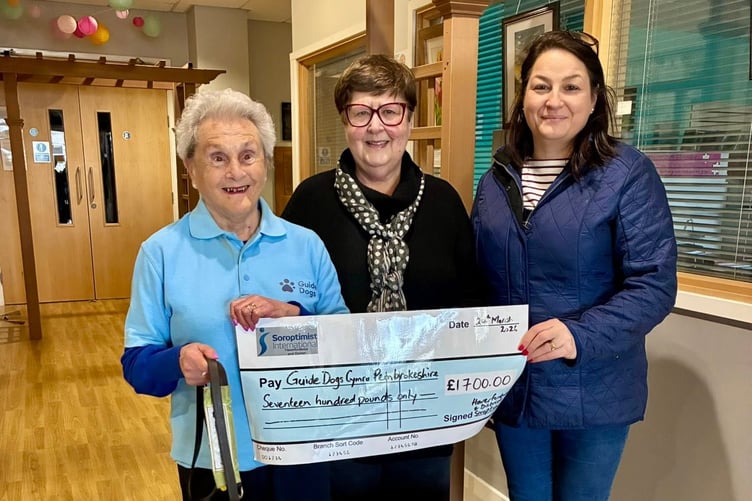 Haverfordwest Soroptimists outgoing president Ruth Howells and events committee chair Deena Irving handing over the cheque to Guide Dogs Cymru Pembrokeshire group organiser Eva Rich