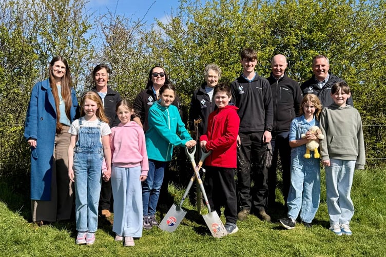 Park Authority representatives and local youth plant a descendant of the Sycamore Gap tree.