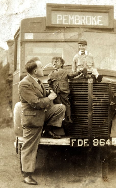 Ernie James with the two dolls and one of his buses