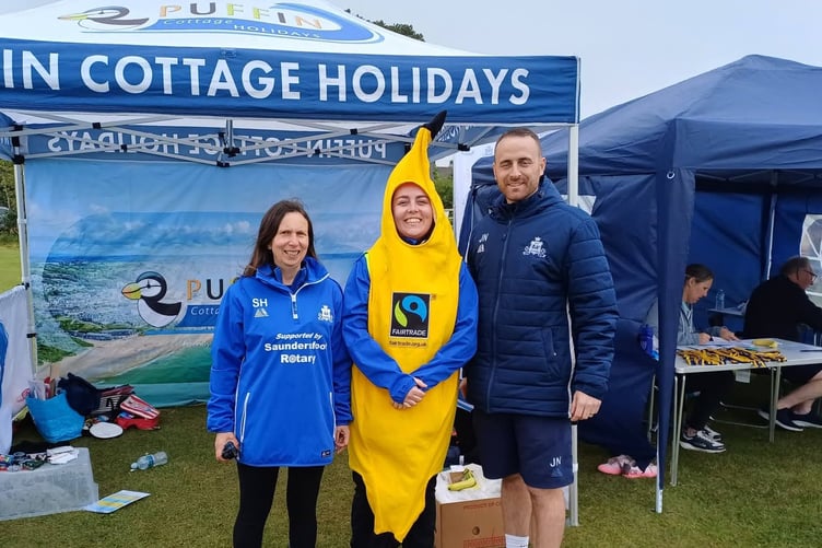 Kilgetty Women’s Captain Maisie Sherratt (wearing the banana suit) is seen with Sharron Hardwick and with James North, organisers of the Kilgetty AFC Junior Football Festival which welcomed over 60 teams, with coaches and spectators from across Pembrokeshire and Wales.