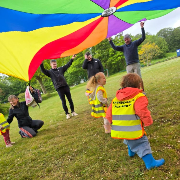 The children played on the grass area with their giant colourful parachute during the Saundersfoot Playgroup Sponsored Toddle.