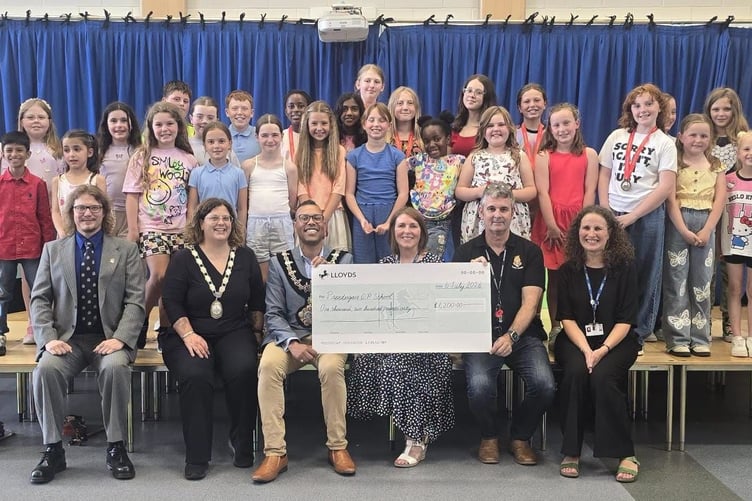 The cheque being presented to Prendergast School